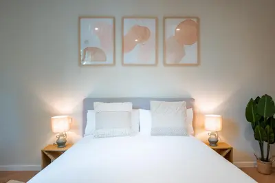 a bedroom with a large white bed with two lamps at CATERINA Sant Pau in Barcelona