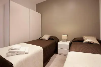 a bedroom with two beds with towels on them at Bed&BCN Enamorats in Barcelona