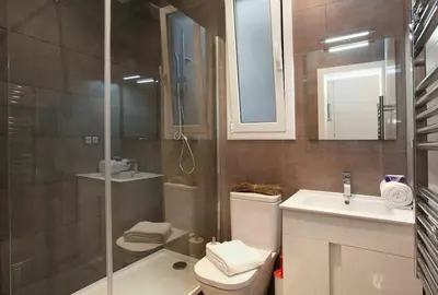 a bathroom with a shower and a toilet and a sink at Bed&BCN Enamorats in Barcelona