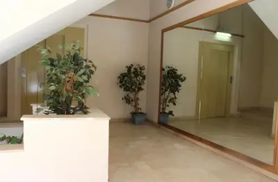 a hallway with potted plants and a mirror at Barcelo al riu in Monistrol