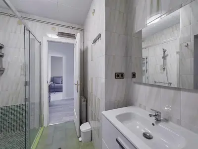 a bathroom with a sink and a walk in shower at Sagrada Familia Penthouse in Barcelona