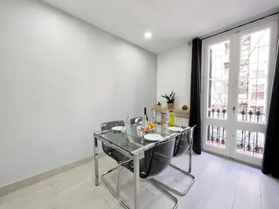 a dining room with a glass table and chairs at Sagrada Familia Gaudi in Barcelona