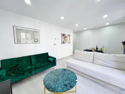 a living room with a green couch and a table at Sagrada Familia Gaudi in Barcelona