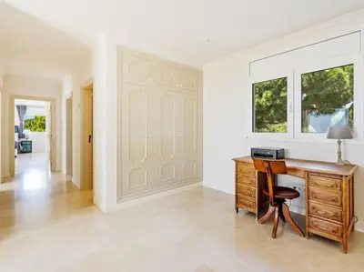 a home office with a wooden desk and a chair at Luxury Villa Buena Vista Pool and Garden in Arenys de Munt