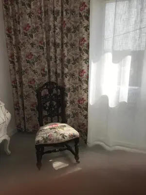a chair sitting in a room with a window at Campagne luxueuse de Sitges in Olivella