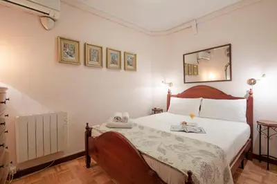 a bedroom with a bed and a mirror on the wall at AB Paralel Blai Apartment in Barcelona