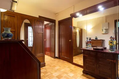 a room with a hallway with wooden doors and a table at AB Paralel Blai Apartment in Barcelona