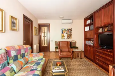 a living room with a couch and a tv at AB Paralel Blai Apartment in Barcelona