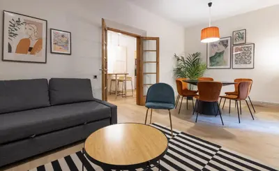 a living room with a couch and a table at Stay U-nique Apartment Gran Via IV in Barcelona