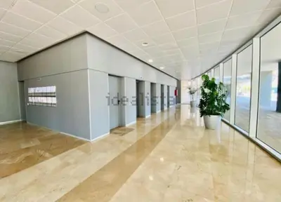 a large empty hallway with a potted plant in a building at Espectacular piso cerca de la playa in Barcelona