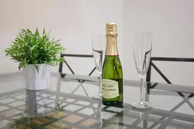 a bottle of champagne and two glasses on a table at Tendency Apartments 7 in Barcelona