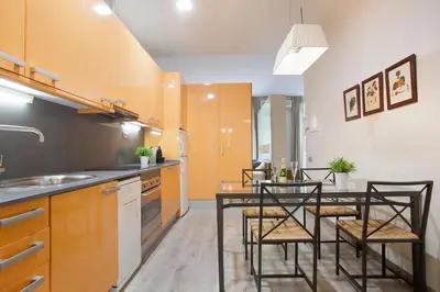 a kitchen with a table and chairs in it at Tendency Apartments 7 in Barcelona
