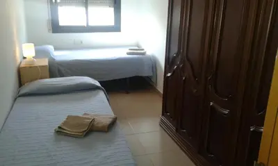 a small bedroom with two beds and a window at New & Sunny Apartment in Barcelona