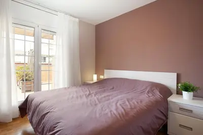 a bedroom with a large bed and a window at LetsGo Sagrada Familia Penthouse in Barcelona