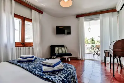 a room with a bed and a chair and a piano at Casa en Sitges in Sitges