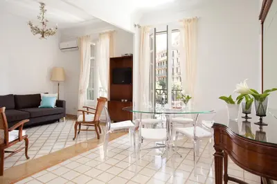 a living room with a glass table and chairs at Casa Muntaner in Barcelona