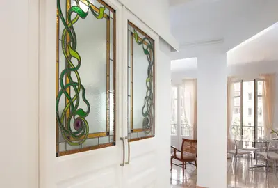 a room with stained glass panels on the wall at Casa Muntaner in Barcelona