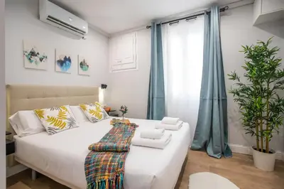 a bedroom with a white bed and a window at Tendency Apartments Miro 6 in Barcelona