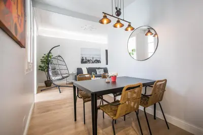 a dining room with a black table and chairs at Tendency Apartments Miro 6 in Barcelona