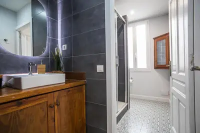 a bathroom with a sink and a mirror at Tendency Apartments Miro 6 in Barcelona