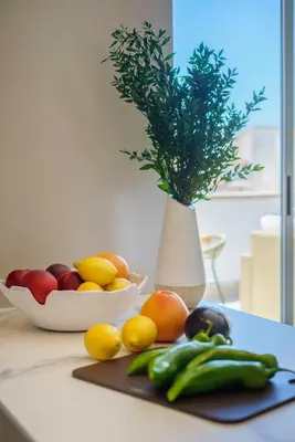 a cutting board with fruits and vegetables on a table at Sitges Spaces Mediterranean Penthouse in Sitges