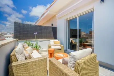 a patio with two chairs and a table at Sitges Spaces Mediterranean Penthouse in Sitges