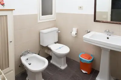 a bathroom with a toilet and a sink at Letsgo Camp Nou Apartment in Barcelona