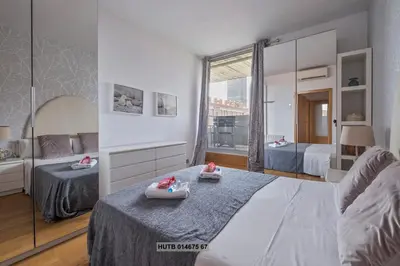 a bedroom with a bed with two babies on it at Alcam Vila Olímpica in Barcelona