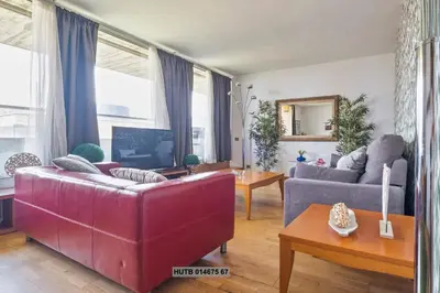 a living room with two couches and a tv at Alcam Vila Olímpica in Barcelona
