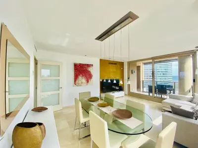 a living room with a glass table and a couch at Akira Flats Diagonal Mar Apartments in Barcelona