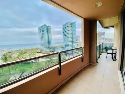 a balcony with a view of the ocean and buildings at Akira Flats Diagonal Mar Apartments in Barcelona