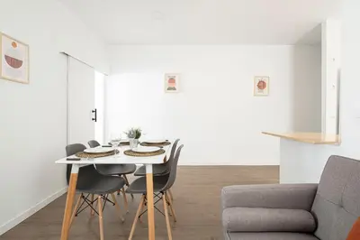 a white dining room with a table and chairs at APARTMENT BEACH PICASSO in Sant Adria de Besos
