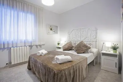 a bedroom with a large bed with two towels on it at Fantástico apartamento en la playa. A/A y vistas in Pineda de Mar