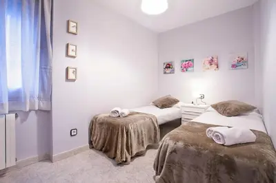 a room with two beds and a sink in it at Fantástico apartamento en la playa. A/A y vistas in Pineda de Mar