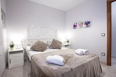 a bedroom with a large bed with towels on it at Fantástico apartamento en la playa. A/A y vistas in Pineda de Mar