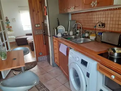 a kitchen with a sink and a washing machine at Maresme´s corner in Sant Andreu de Llavaneres