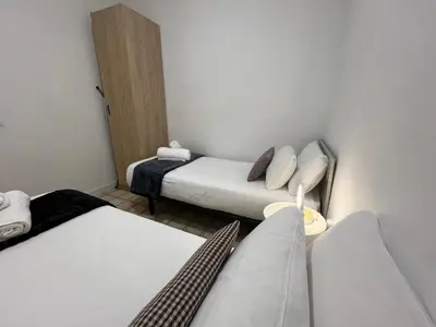 a small room with two beds and a couch at Apartamento moderno en Sant Antoni in Barcelona