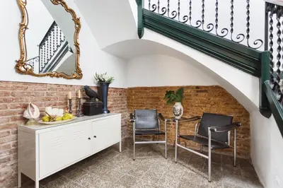 a room with a staircase and a table and chairs at The Patio Barcelona in Barcelona