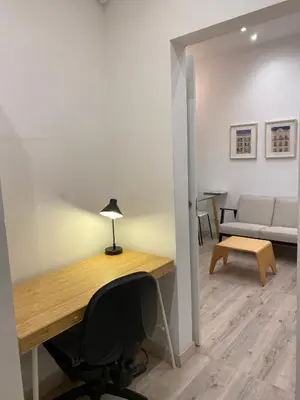 an office with a desk and a chair and a couch at Cozy near the Barcelona Camp Nou Stadium in Barcelona