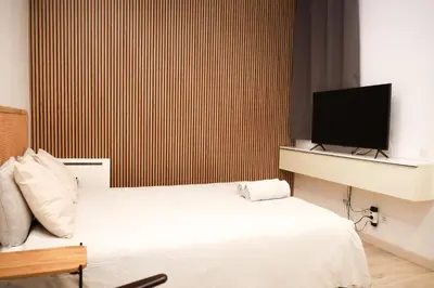 a bedroom with two beds and a flat screen tv at Cozy near the Barcelona Camp Nou Stadium in Barcelona