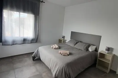 a bedroom with a bed with two towels on it at CASA CENTRO DEL PUEBLO CON PISCINA PRIVADA in Sant Vicenç de Montalt