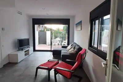 a living room with a couch and chairs and a television at CASA CENTRO DEL PUEBLO CON PISCINA PRIVADA in Sant Vicenç de Montalt