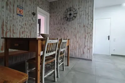 a dining room with a wooden table and chairs at CASA CENTRO DEL PUEBLO CON PISCINA PRIVADA in Sant Vicenç de Montalt