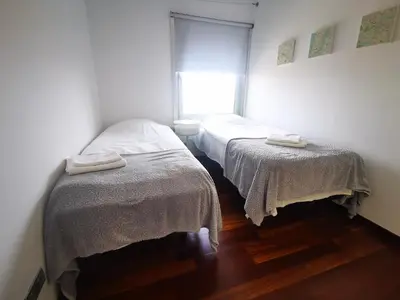two beds in a small room with a window at Ral48 in Sant Adria de Besos