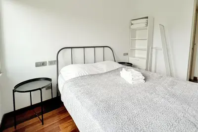 a bedroom with a bed with a white bedspread at Ral48 in Sant Adria de Besos