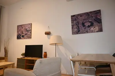 a living room with a table and a television at Homenfun Barcelona Vallcarca in Barcelona