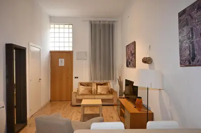 a living room with a couch and a table at Homenfun Barcelona Vallcarca in Barcelona