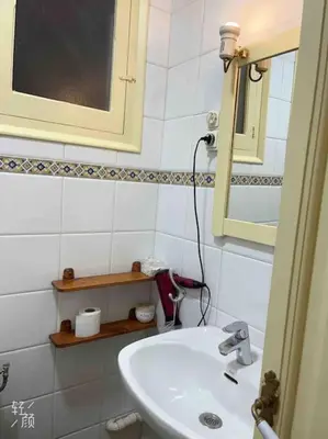 a white bathroom with a sink and a mirror at Loft nearby Sagrada Familia in Barcelona