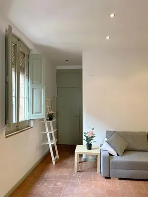 a living room with a couch and a table at SC Apartamento céntrico con balcón in Terrassa