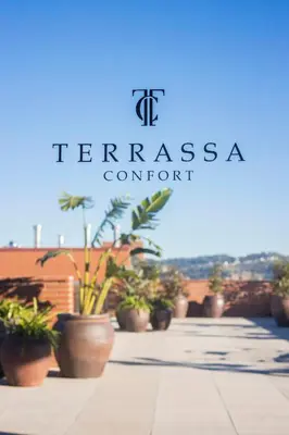a group of potted plants sitting on a sidewalk at Hotel Terrassa Confort in Terrassa